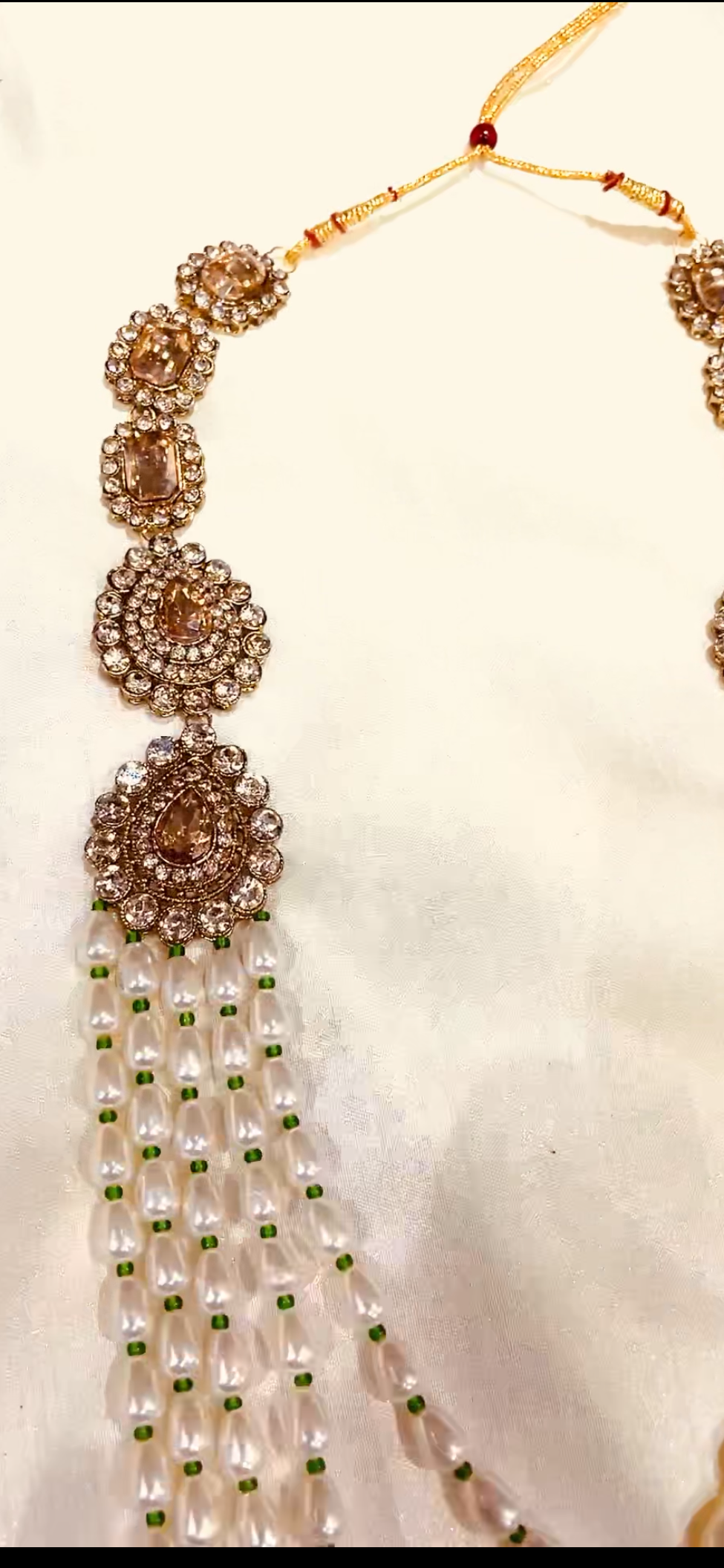 Groom’s pearl and antique gold necklace with green beadwork